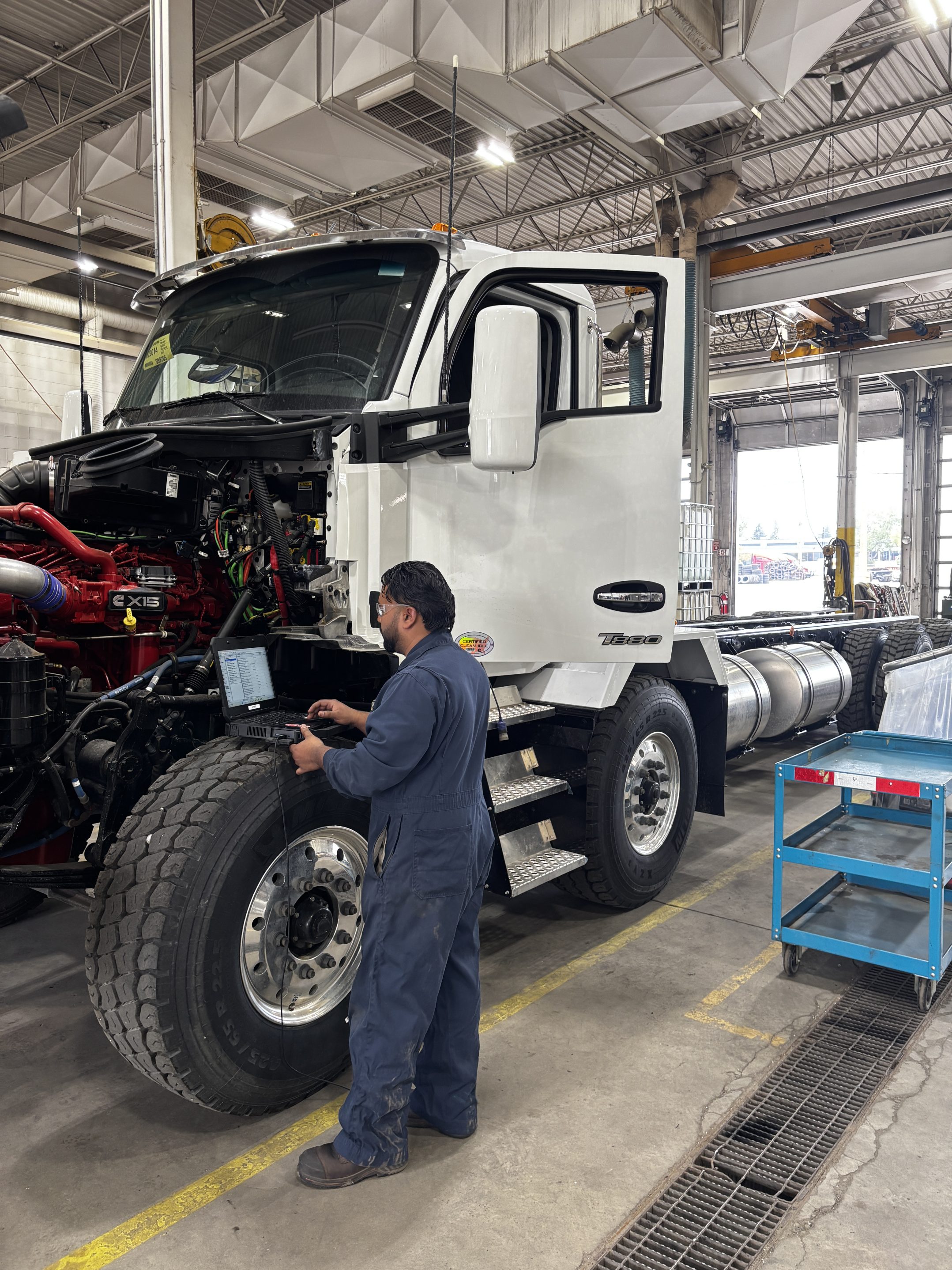 Kenworth employee doing truck service